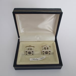 A sterling silver stamped 925 pair of black onyx openwork design panel cufflinks in box case 9.73 grams