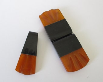 An Art Deco large butterscotch Bakelite buckle and clip set