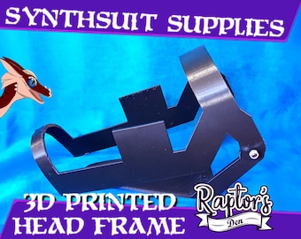 May include: Black 3D-printed head frame for synthsuit supplies. The frame is made of black plastic and has a geometric design. The text "SYNTHSUIT SUPPLIES" and "3D PRINTED HEAD FRAME" are visible.
