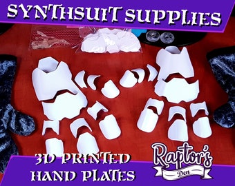 May include: White 3D printed hand plates for a synthsuit costume. The plates are laid out on a red surface. The image includes the text "Synthsuit Supplies" and "3D Printed Hand Plates".