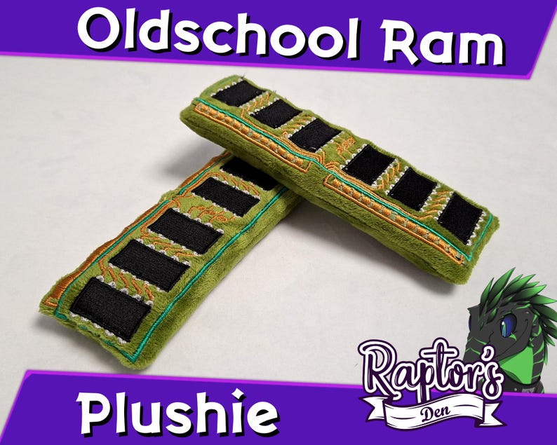 May include: Two rectangular plushies shaped like computer RAM sticks, featuring olive green fabric with embroidered gold circuit patterns and black rectangular accents. The text Oldschool Ram Plushie and Raptors Den is visible.