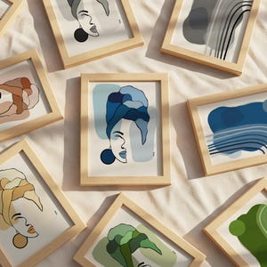 a collection of framed artworks featuring abstract illustrations of faces and nature.