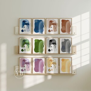 a collection of abstract artworks arranged in a grid-like pattern on a wall, with each artwork featuring a stylized face or head.