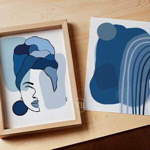 two framed artworks with abstract blue and white designs.