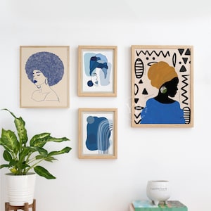 a white wall with four framed artworks displayed on it. The artworks include a portrait of a woman with a blue headscarf, abstract art in shades of blue and white, and a portrait of a woman with a yellow headscarf. There is also a potted plant in the foreground, adding a touch of greenery to the scene.