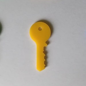 Könnte beinhalten: Drei Plastik-Schlüssel, einer grün, einer gelb und einer blau. Die Schlüssel sind alle gleich geformt und groß.