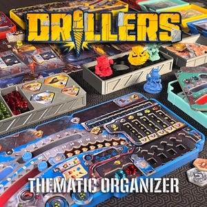 May include: A board game organiser set for Drillers featuring multiple plastic trays in various colours including blue, red, yellow, and green. The set includes containers for game components, cards, and tokens, with a central blue tray displaying game board elements and numerical tracks.