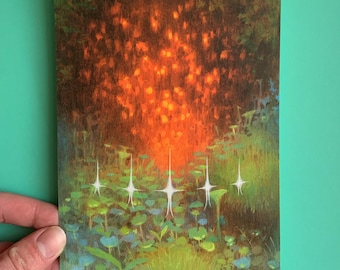 May include: A postcard featuring an artistic illustration of a forest scene. The artwork depicts a vibrant orange and red light emanating from the top, with white star-like shapes and green foliage in the foreground. The overall aesthetic is reminiscent of a dreamscape.