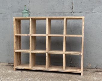 Shelving unit made from recycled wood, construction timber, and scaffolding planks with square compartments for ample storage space. Suitable as a filing shelf, vinyl shelf, or living room shelf.