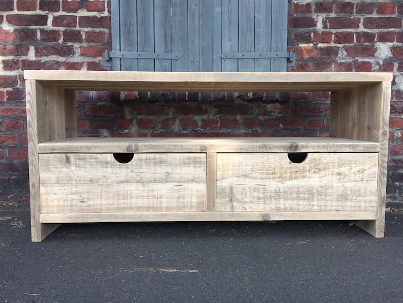 May include: A rustic wooden TV stand with two drawers and an open shelf. The stand is made of reclaimed wood and has a natural, weathered finish.