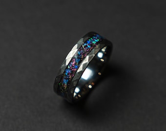 May include: A silver ring with a hammered finish and a band of iridescent blue, purple, and pink opal inlay.