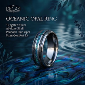 Op de afbeelding: Een ring van wolfraamzilver met een inleg van abalone schelp en pauwblauw opaal. De band is 8 mm breed met een comfortabele pasvorm. De tekst op de afbeelding luidt DECAZI OCEANIC OPAL RING, Tungsten Silver, Abalone Shell, Peacock Blue Opal, 8mm Comfort Fit.