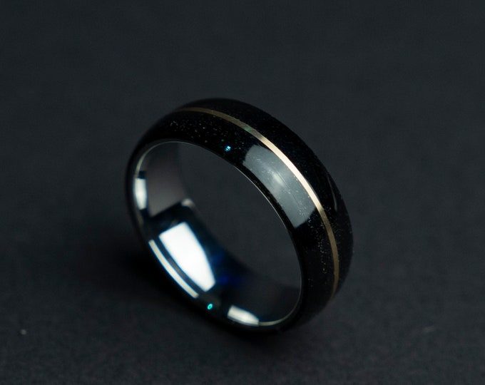 Solid domed black tungsten ring with a 18K gold line.