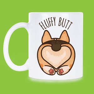 May include: White ceramic coffee mug with a cartoon image of a dog's rear end with the text "FLUFFY BUTT" printed on the mug.