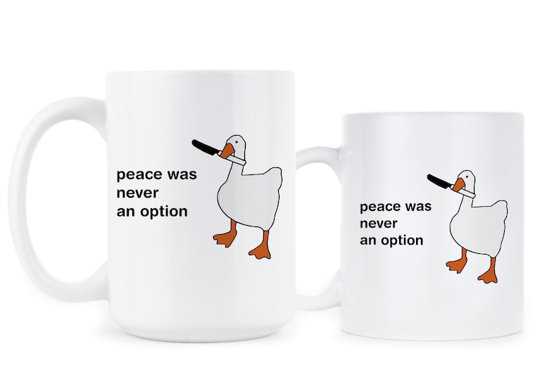 May include: Two white ceramic mugs with a black and white illustration of a goose holding a knife. The text on the mugs reads "peace was never an option".
