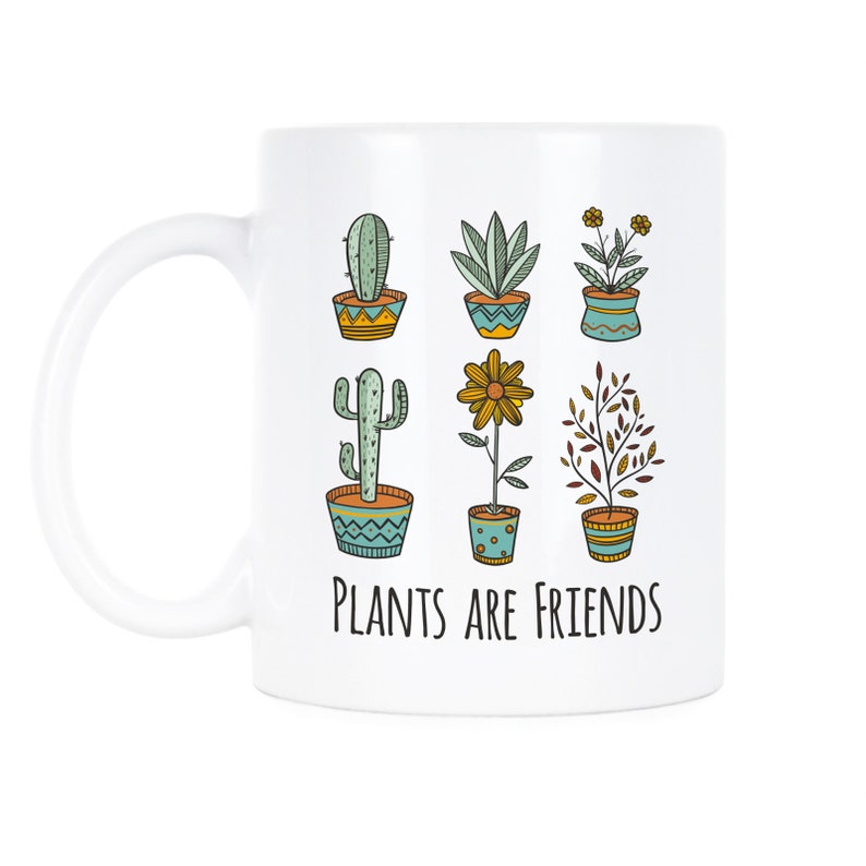 May include: White ceramic mug with a colorful illustration of six potted plants and the text "Plants are friends".