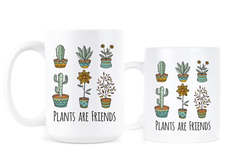 May include: Two white ceramic mugs with a black outline of various potted plants and the text "Plants are Friends".