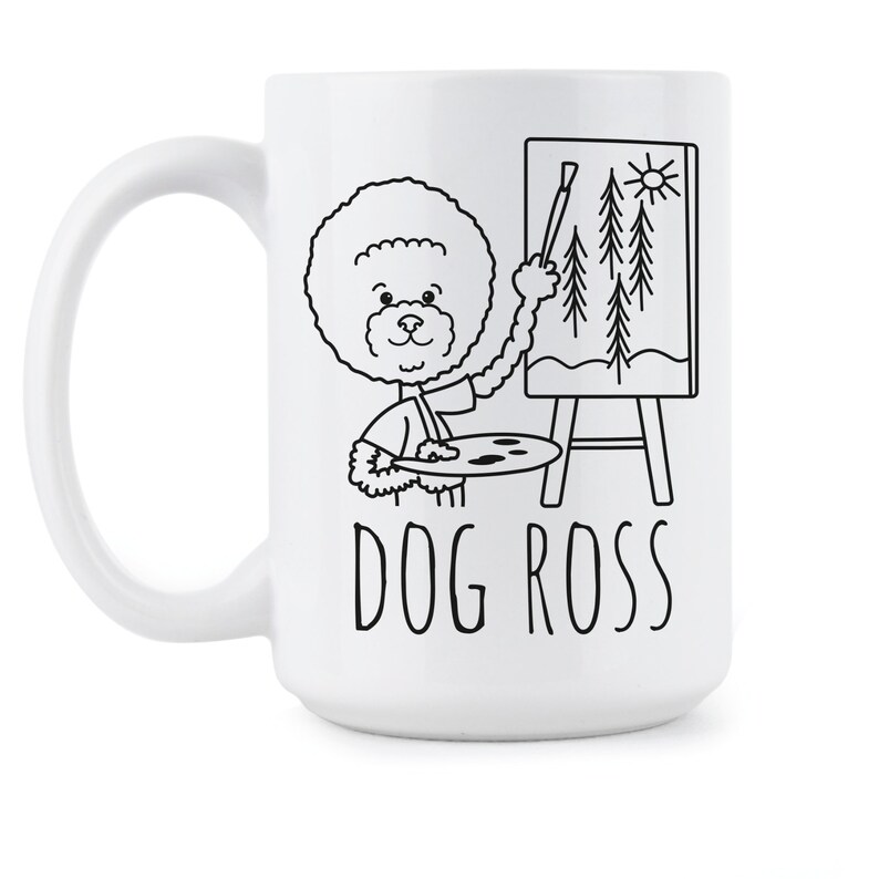 May include: White ceramic coffee mug with a black and white illustration of a dog painting a landscape on a canvas. The text "DOG ROSS" is printed below the illustration.