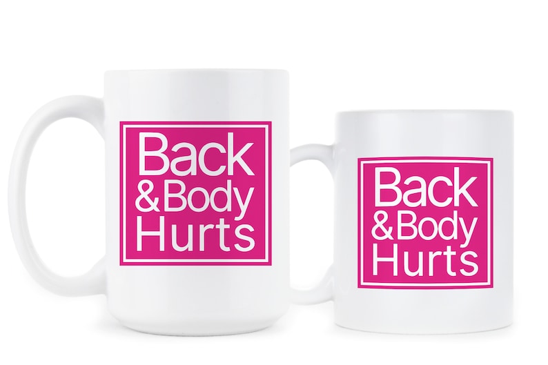 May include: Two white coffee mugs with a pink square design that says "Back & Body Hurts" in white text.