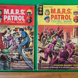May include: Two vintage comic books with covers featuring illustrations of futuristic space battles. The covers are red, white, and blue with the title "M.A.R.S. PATROL TOTAL WAR" and the text "Marine Attack Rescue Service".