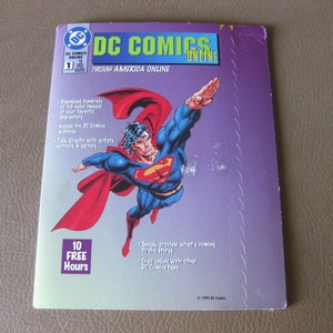 May include: A purple and white magazine cover with the title "DC Comics Online: Through America Online". The cover features a comic book illustration of Superman flying with a red cape. The magazine cover also includes the text "10 Free Hours".