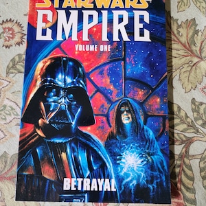 May include: A Star Wars Empire comic book cover featuring Darth Vader and a dark figure with a glowing blue orb. The title is "Star Wars Empire Volume One: Betrayal".