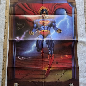 May include: A Superman poster featuring the superhero in a dynamic pose, with a red and blue costume, and a red cape. The poster has the word "SUPERMAN" at the top and a signature. Lightning bolts and a cityscape are in the background.