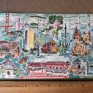 May include: A vintage postcard depicting a colorful illustration of famous San Francisco landmarks, including the Golden Gate Bridge, Coit Tower, and Fisherman's Wharf. The postcard advertises Grison's Steak House and Chicken House, located at Van Ness at Pacific in San Francisco, California.