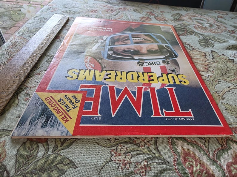 May include: A vintage TIME magazine cover featuring a football player in a helmet. The cover has a red, white, and blue color scheme with the headline "SUPERDREAMS" in yellow. The issue date is January 25, 1982.
