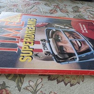 May include: A vintage January 1982 TIME magazine cover featuring a football player in a helmet. The cover has the headline "SUPERDREAMS" in yellow and the player's face is visible through the helmet's face mask. The magazine has a red border.
