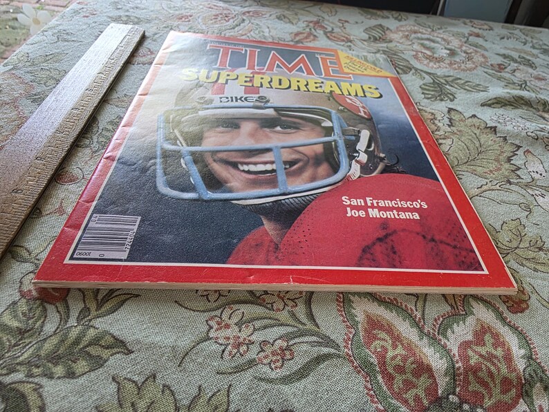 May include: A vintage TIME magazine cover featuring a smiling football player in a helmet. The cover has the title "SUPERDREAMS" and the text "San Francisco's Joe Montana" on a red background.