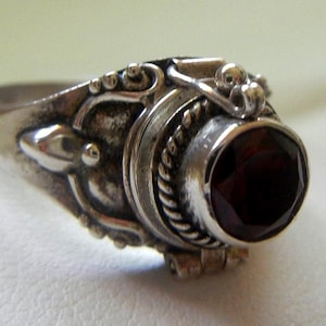 Poison Balinese garnet and sterling silver ring 3.3grams, size 6.75. Silver Bali poison ring.  Silver Bali jewelry.  Garnet poison Bali ring
