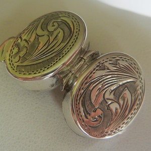 Tiny oval double-sided embossed snuff box sterling silver 4.5 grams, 3/4&quot; x 5/8&quot;.  Small vintage silver snuff or pill box.  Mens snuff box.