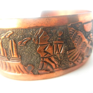 Pulseira Navajo Elaine Becenti Contadora de Histórias em Cobre: Pássaros-trovão, Pessoas, Sol, Plantas e Árvores, Montanhas, 19 cm x 2,5 cm.