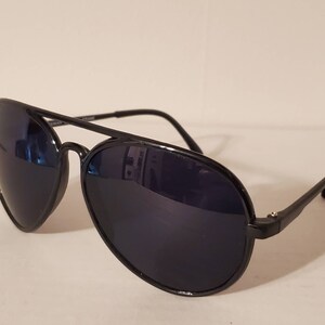 May include: Black aviator sunglasses with dark lenses. The sunglasses have a metal frame and are in good condition.