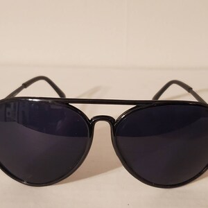 May include: Black aviator sunglasses with dark lenses and a metal frame.