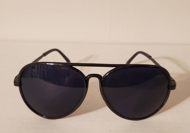 May include: Black aviator sunglasses with dark lenses and a metal frame.