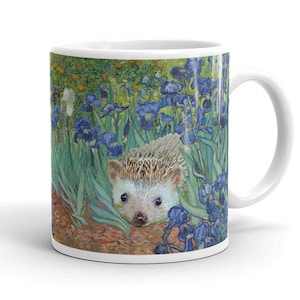 May include: A white ceramic coffee mug with a colorful image of a hedgehog in a field of blue irises. The image is reminiscent of a famous painting.