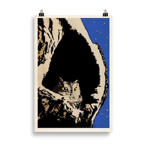 May include: A vintage poster print showing a cat peeking from a dark, tree-like form. The cat has yellow eyes, set against a blue night sky with yellow stars. The artwork has a retro aesthetic, reminiscent of classic illustrations.