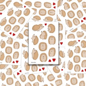 May include: A sheet of stickers featuring cute cartoon hedgehogs in various poses. The stickers are printed on white paper and have a glossy finish. The sheet includes a variety of hedgehog designs, including hedgehogs with hearts, hedgehogs with flowers, and hedgehogs with different facial expressions. The stickers are perfect for adding a touch of whimsy to your planner, laptop, or water bottle.
