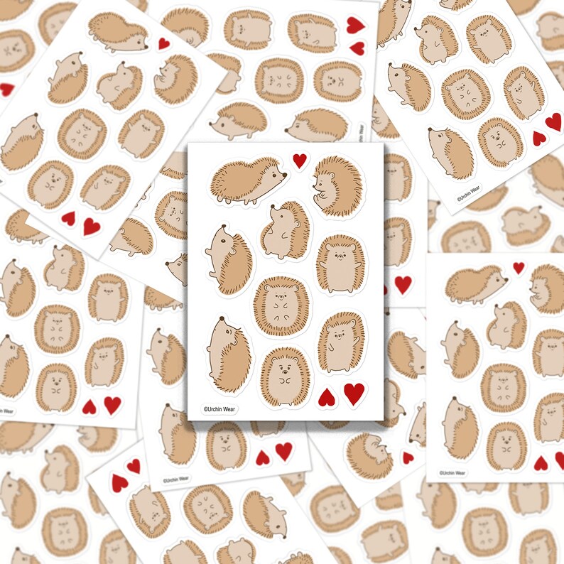 May include: A sheet of stickers featuring cute cartoon hedgehogs in various poses. The stickers are printed on white paper and have a glossy finish. The sheet includes a variety of hedgehog designs, including hedgehogs with hearts, hedgehogs with flowers, and hedgehogs with different facial expressions. The stickers are perfect for adding a touch of whimsy to your planner, laptop, or water bottle.
