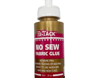 May include: A gold-colored bottle of Hi-Tack No Sew Fabric Glue with a white nozzle. The label is red and white, with the text "NO SEW FABRIC GLUE". The bottle contains 2 fl oz of glue.