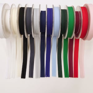 May include: Assortment of 10 spools of ribbon in various colours, including white, black, grey, light blue, navy blue, green, burgundy, red, and pink. The ribbon is displayed on a white background.