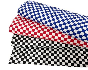 May include: Three rolls of checkered fabric in blue and white, red and white, and black and white. The fabric is tightly rolled, showcasing the repeating square pattern. The fabric is likely cotton or a similar material.