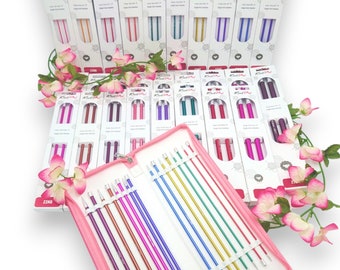 May include: A set of colourful knitting needles in a pink case. The needles are arranged in a row and are labelled with different sizes. The case has a zipper closure and is made of a soft, durable material.
