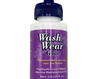 May include: A white bottle of Wash & Wear Glue with a purple label and a dark blue cap. The label includes the text "Wash & Wear Glue" and details about the glue's use for appliqués, lace, and ribbons. The bottle contains 2.03 fl oz.