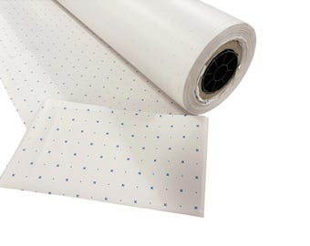 May include: A large roll of white paper featuring a repeating pattern of small blue cross symbols and tiny dots. The paper is tightly wound around a black plastic core, with a portion of the patterned sheet unrolled and laid flat in the foreground.