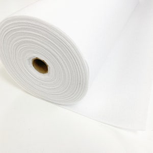 May include: A white roll of felt fabric. The felt is rolled up and the end of the roll is visible.