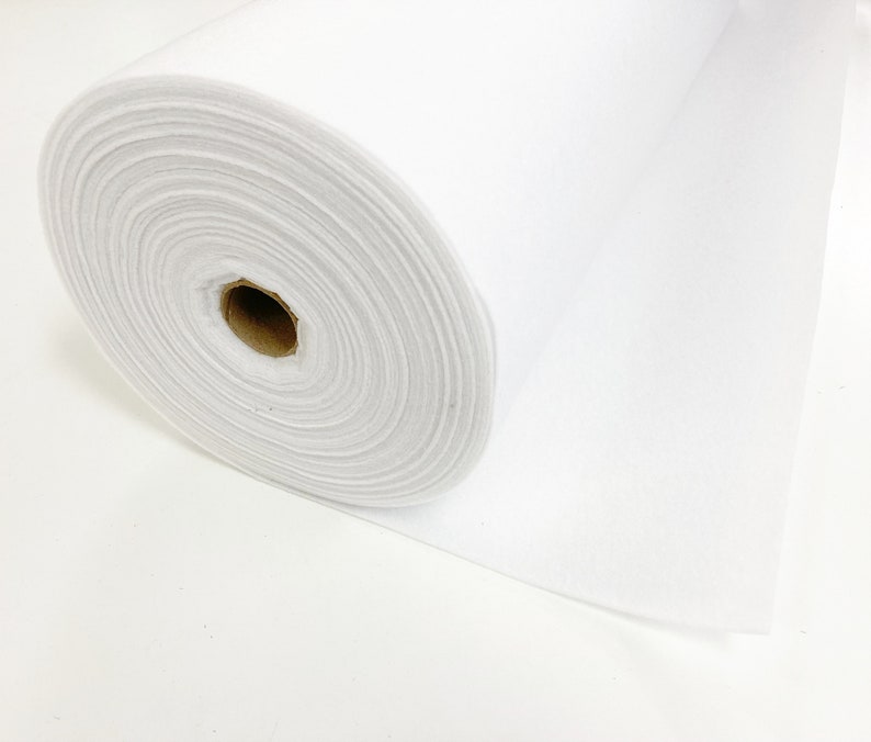 May include: A white roll of felt fabric. The felt is rolled up and the end of the roll is visible.