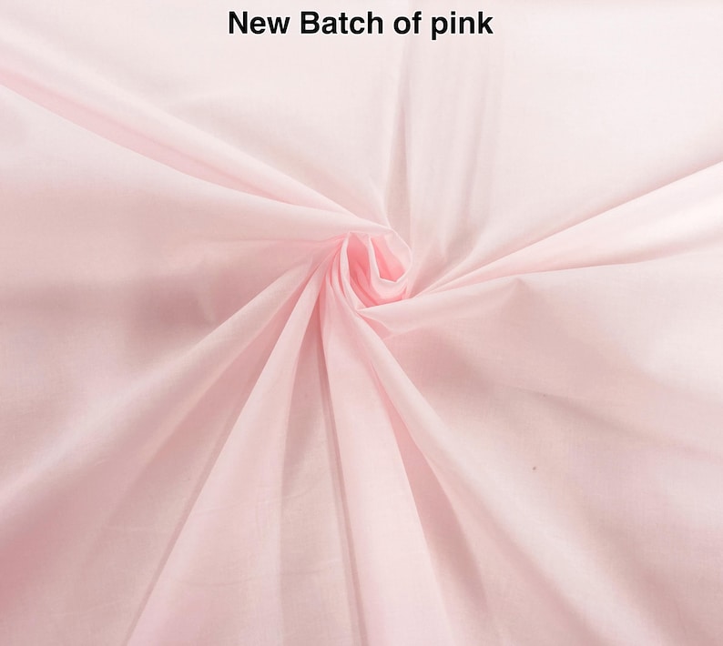 May include: A light pink fabric with a smooth texture, gathered in the center to create radiating folds. The text New Batch of pink is printed in black at the top center of the image, clearly visible against the pale pink background.